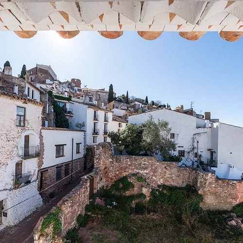 View of Apartamentos Vilafames Antic Palau from a window with an arch.