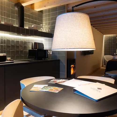 Interior of Vilafames Antic Palau tourist apartments: kitchen, dining table, and bed.