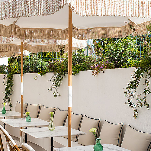 Exterior seating area with umbrellas and tables at a Villa Dorothea.