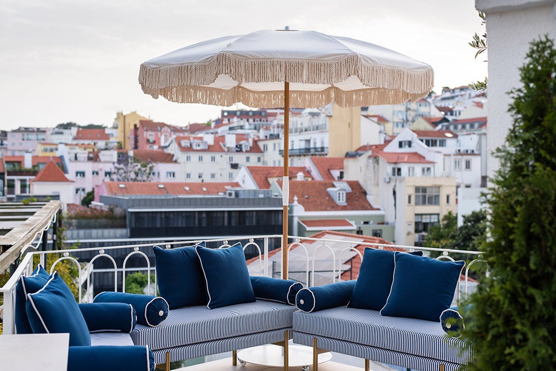 Rooftop terrace with sofas and umbrella offering city views Villa Dorothea