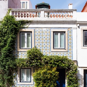 Charming Villa Dorothea entrance with azulejo tiles and lush greenery.