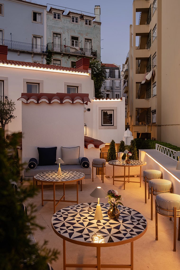 Rooftop terrace Villa Dorothea at a charming hotel, featuring stylish seating and tables.