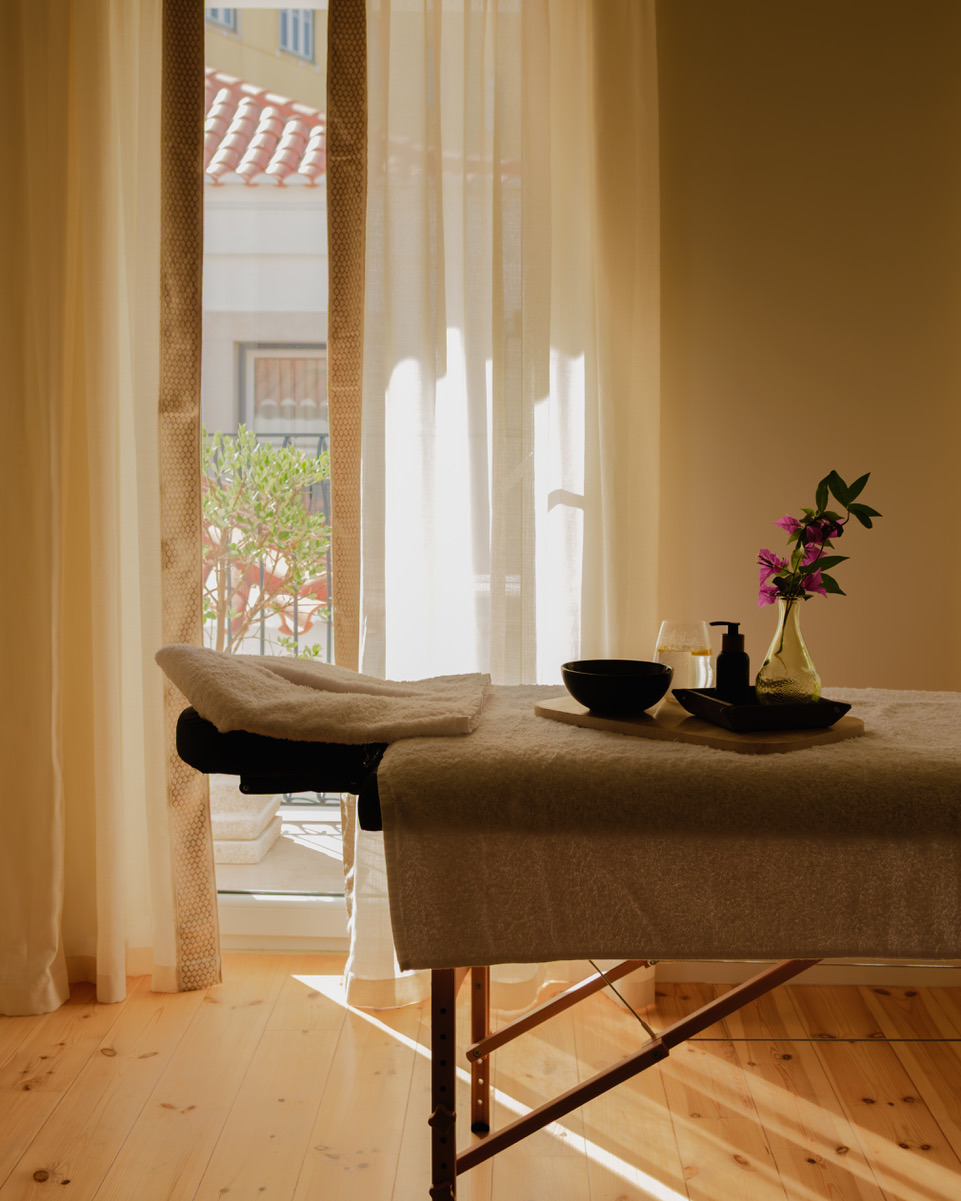 Massage table ready for relaxation Villa Dorothea. Spa room with natural light and balcony view.