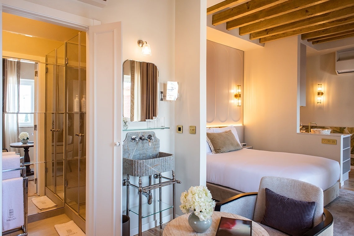 Quarto de hotel moderno e luxuoso com cama confortável, banheiro elegante e design sofisticado.