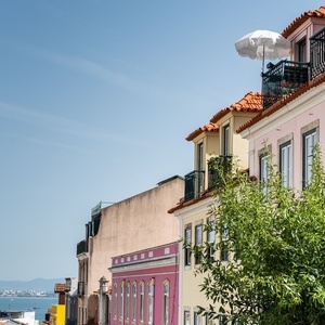 Villa Dorothea hotel balconies with umbrellas offer city views.