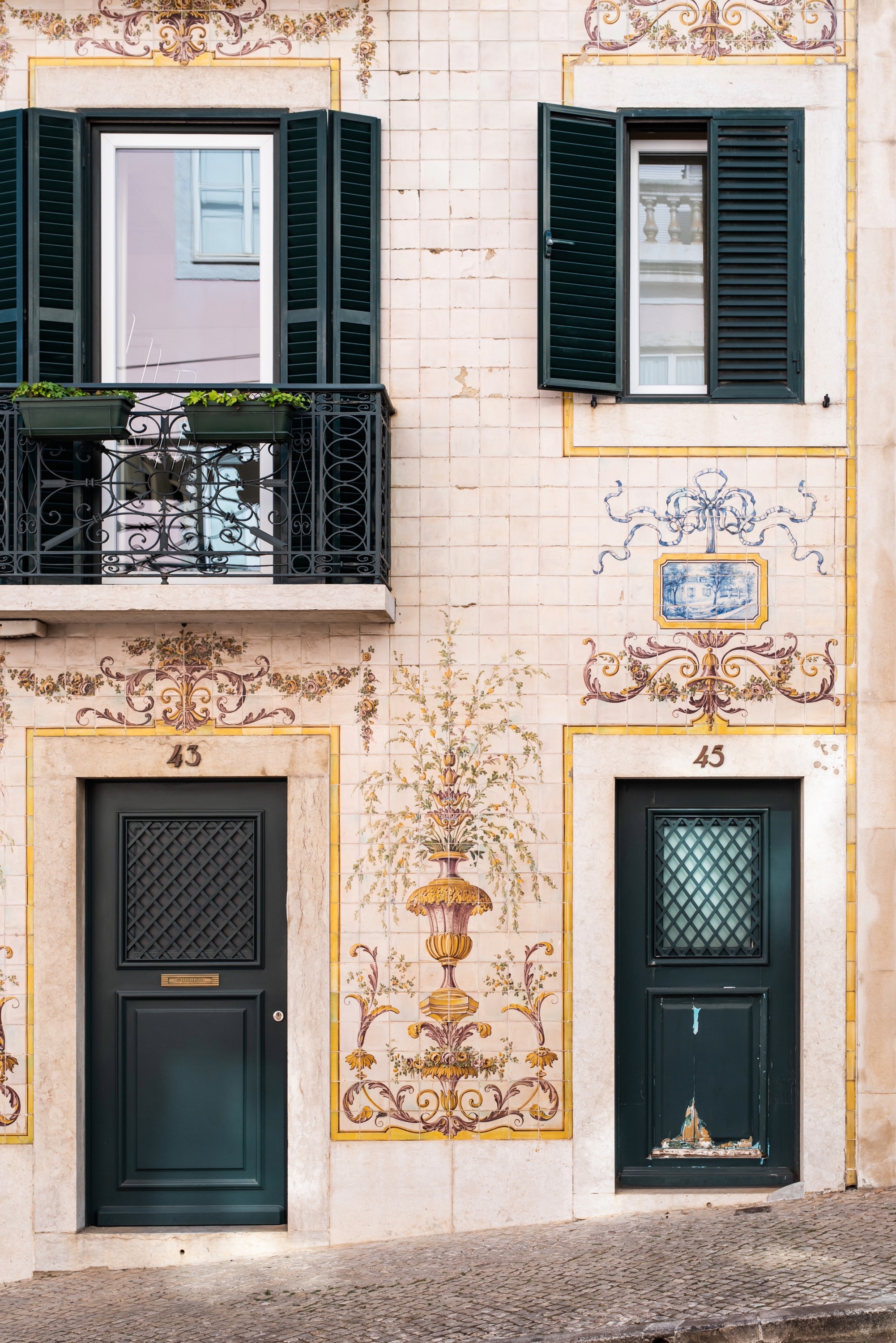Quarto elegante na Villa Dorothea com cama luxuosa, sofá, espelho e vigas de madeira.