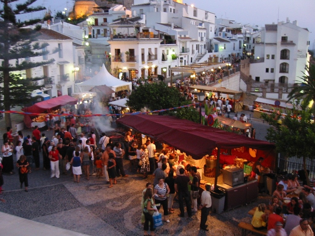 a crowd of people are gathered in front of a food stand that says ' coca cola ' on it