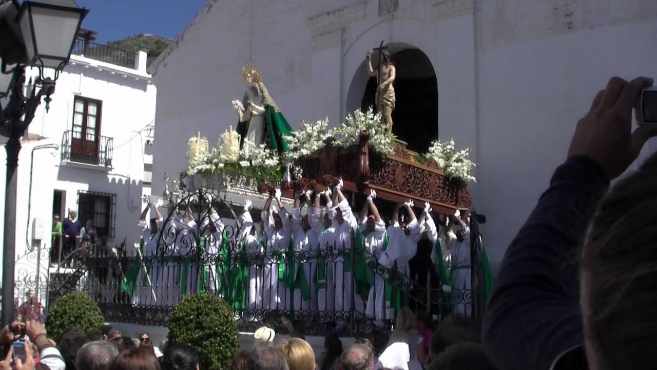 a group of people holding up their hands in front of a statue of jesus