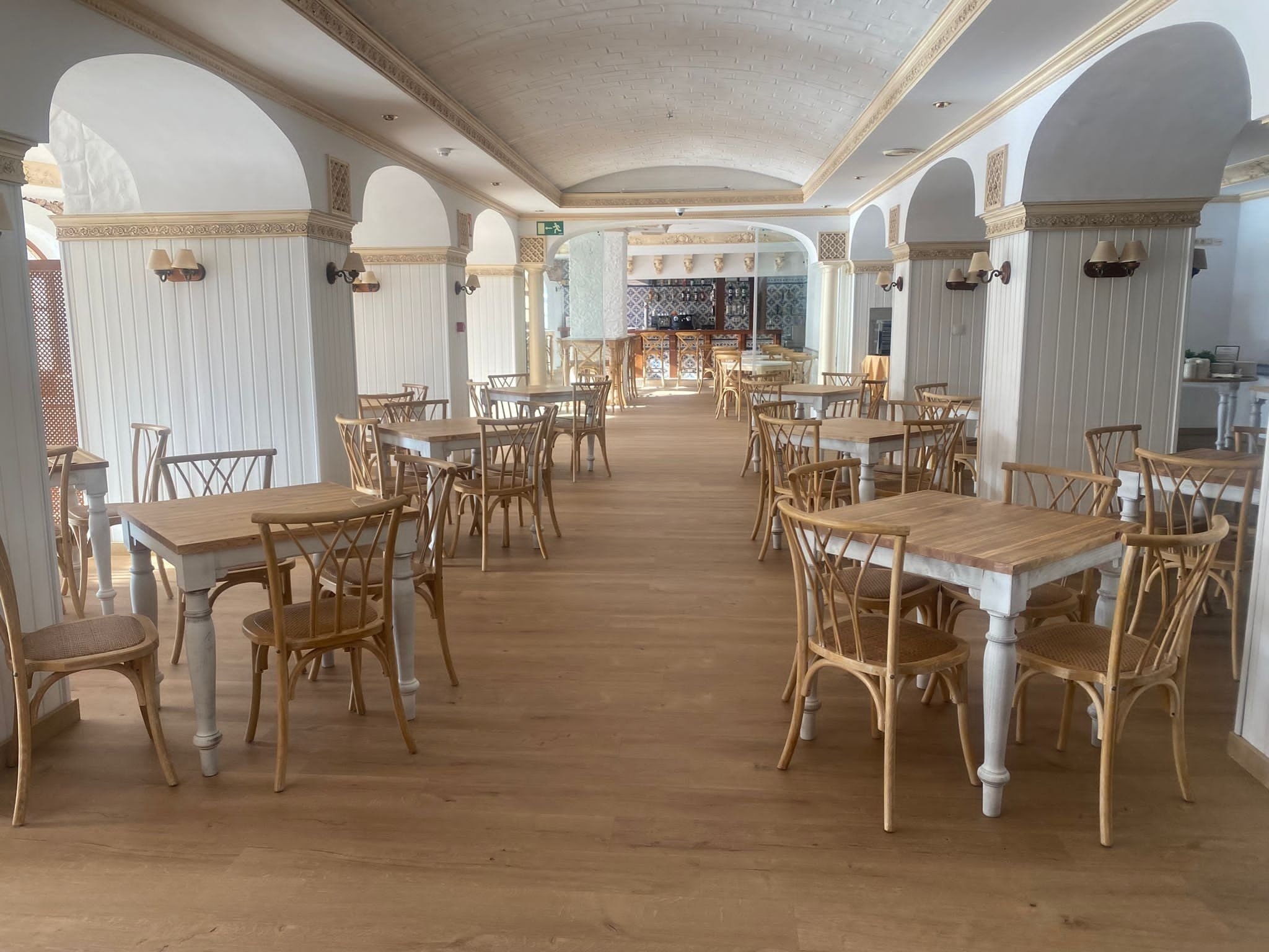 un restaurante vacío con mesas y sillas de madera