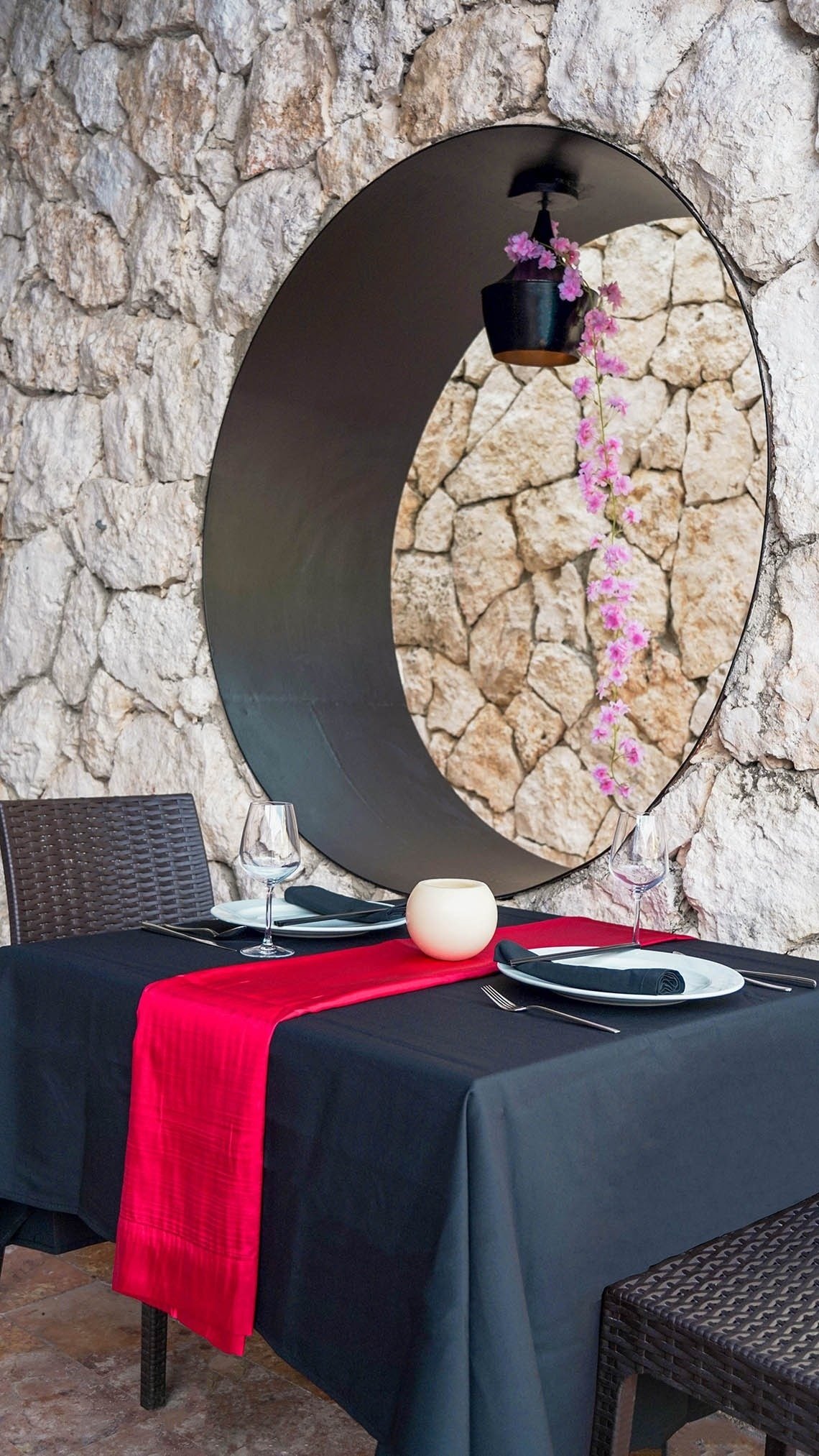 a table with a black table cloth and a red table runner