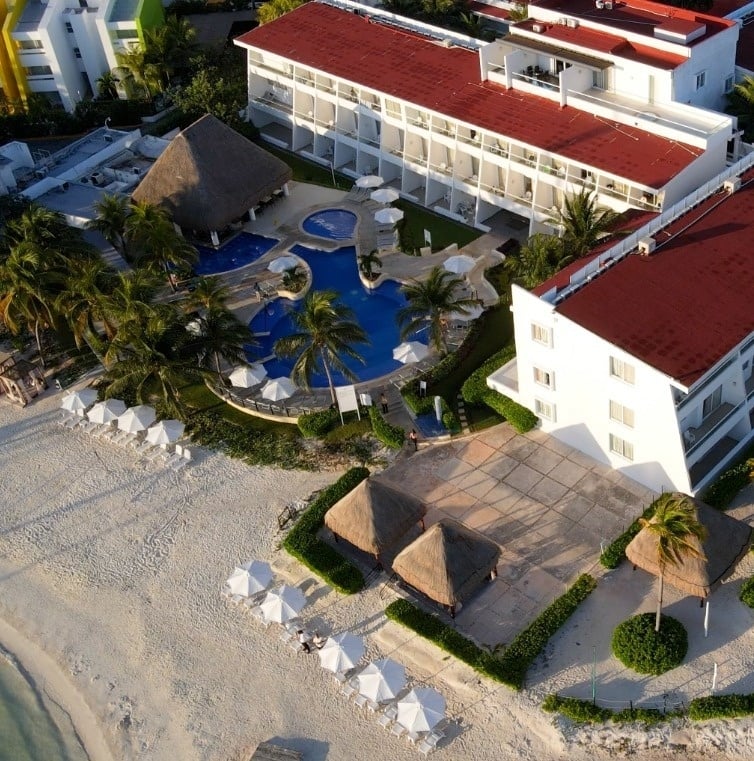 an aerial view of a resort with a large pool