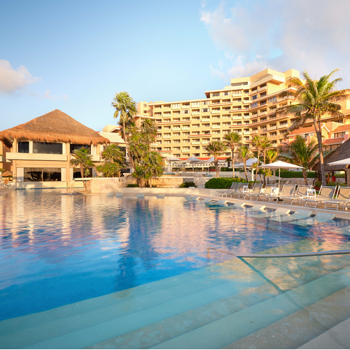 a large swimming pool in front of a hotel