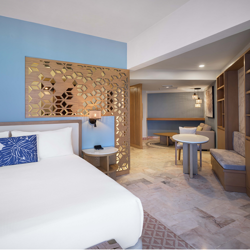 a hotel room with a king size bed and a table