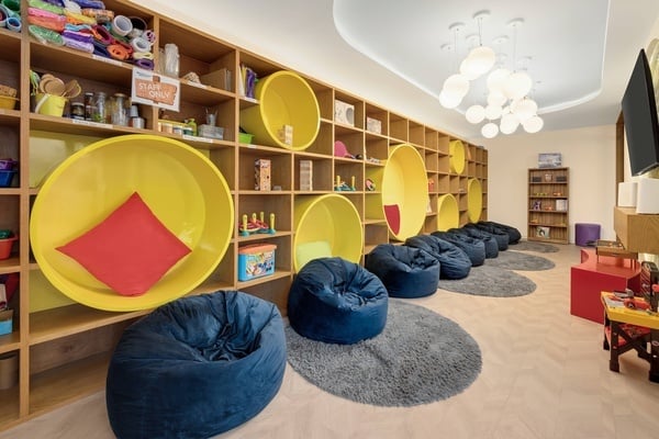 a twister game sits on a shelf in a play room