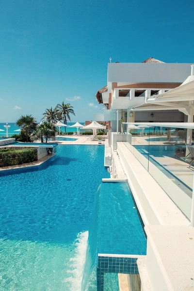 a large swimming pool with a waterfall in the middle