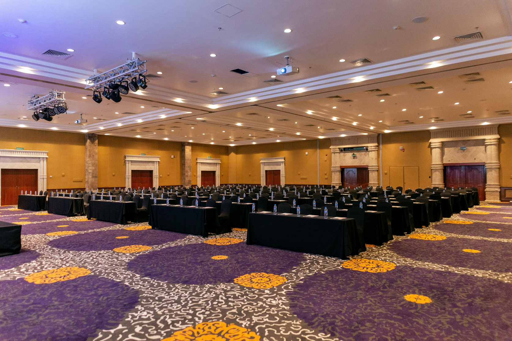 a large room with rows of tables and chairs