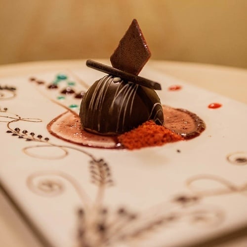 a white plate with a chocolate dessert on it