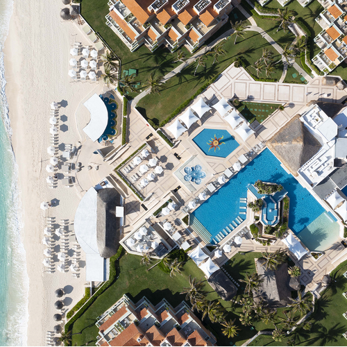 an aerial view of a resort with a large pool