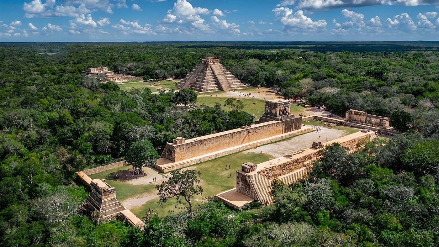 an aerial view of a pyramid surrounded by trees