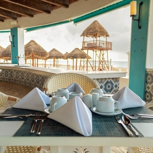 a restaurant table with a view of the ocean