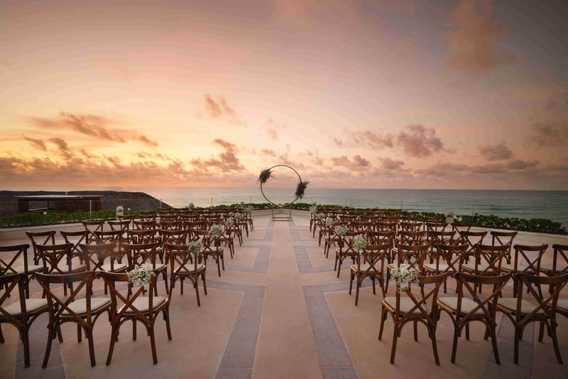 rows of chairs are set up for a wedding ceremony overlooking the ocean