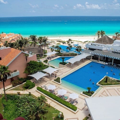 an aerial view of a resort with a large swimming pool