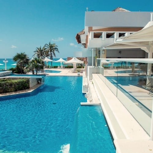 a large swimming pool with a waterfall in the middle