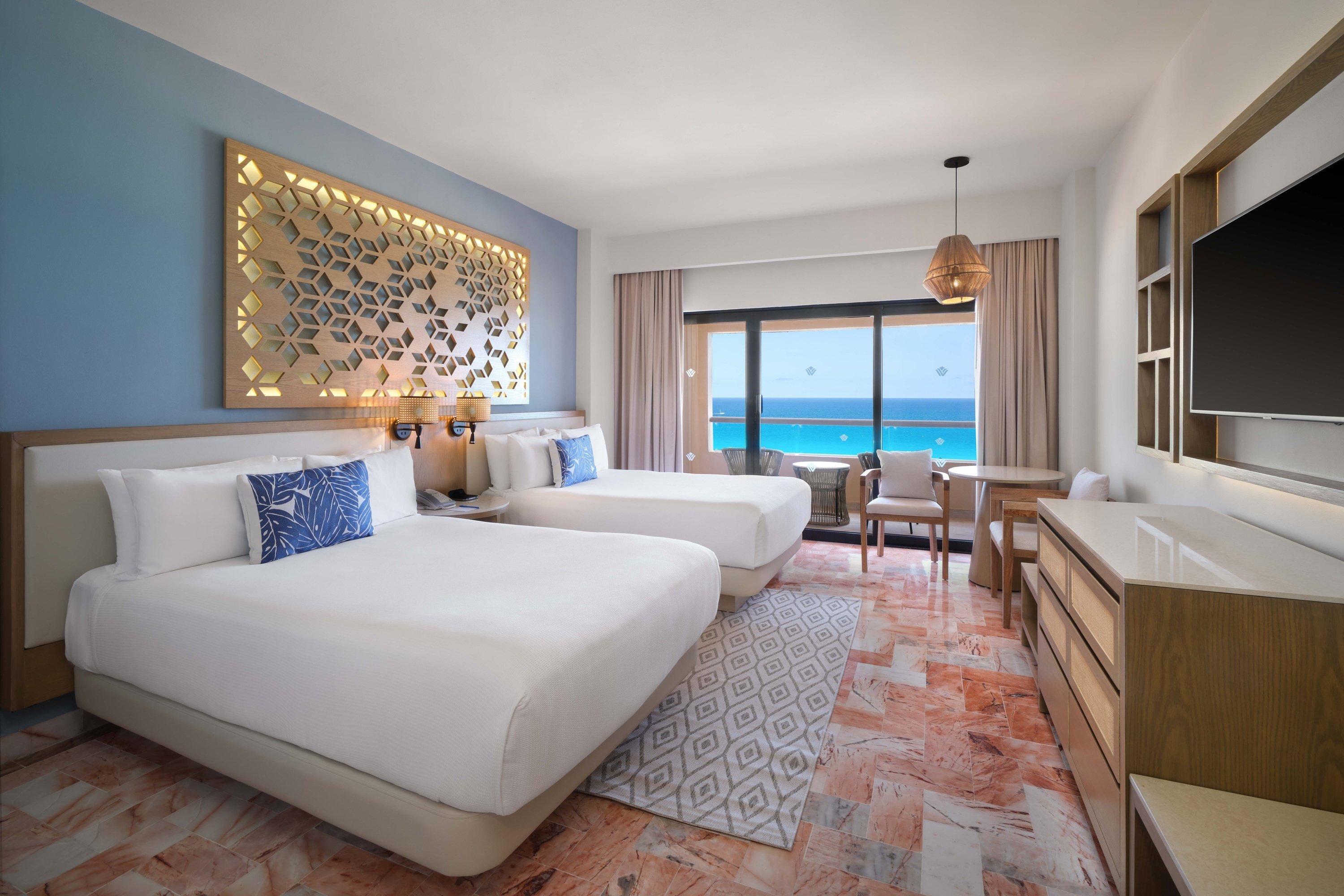 a hotel room with a king size bed , television , dresser and chair .