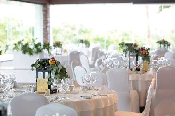 a table with plates and silverware and a vase of flowers on it