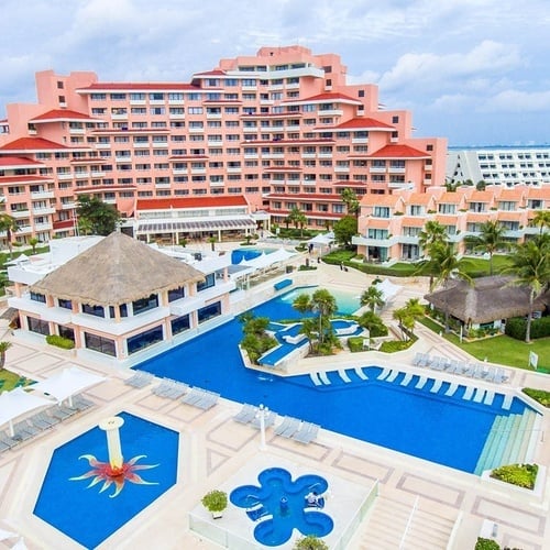 an aerial view of a resort with a large pool