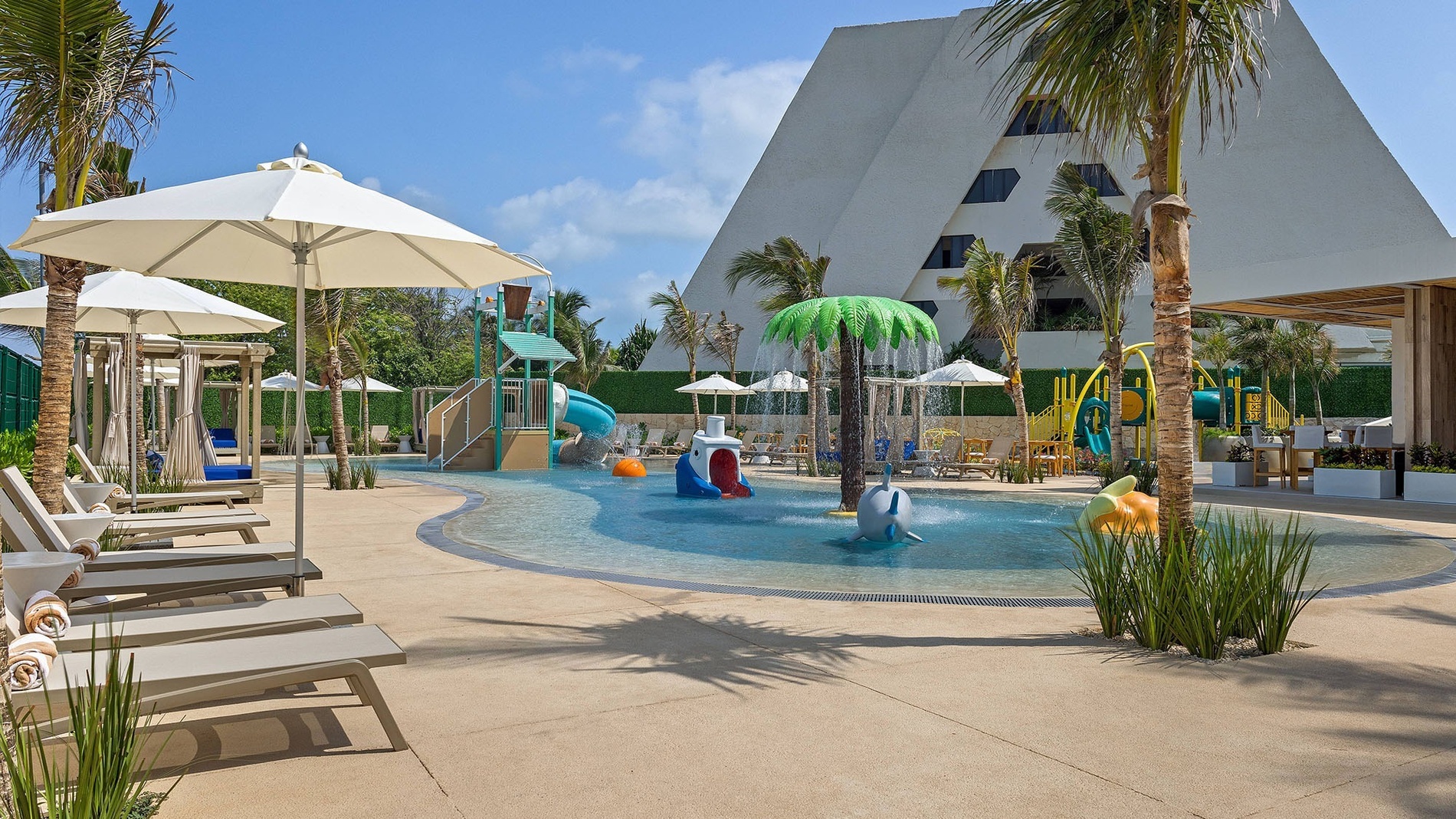 a group of boats are docked at a dock on a beach