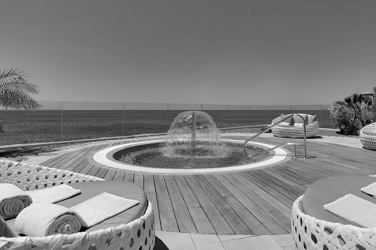 a black and white photo of a hot tub with a fountain