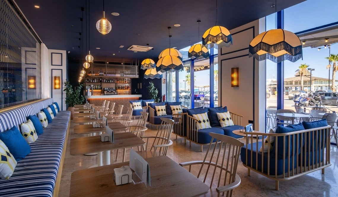 an artist 's impression of a restaurant with a bar and a couch