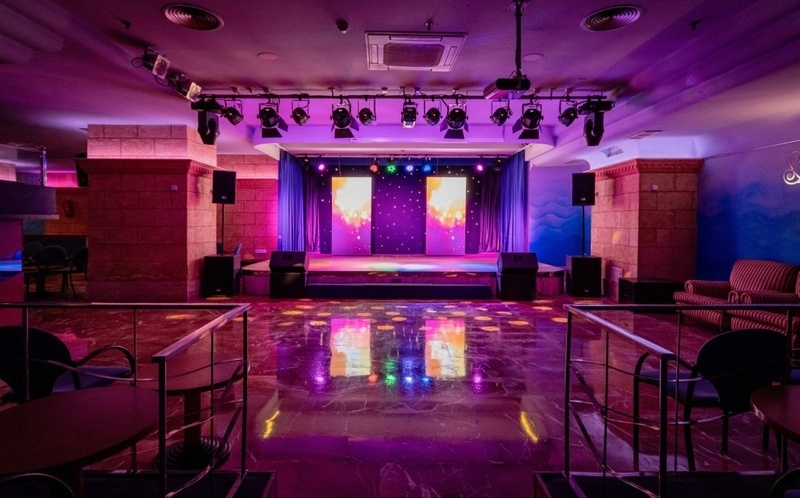 an empty dance floor with purple lights on it