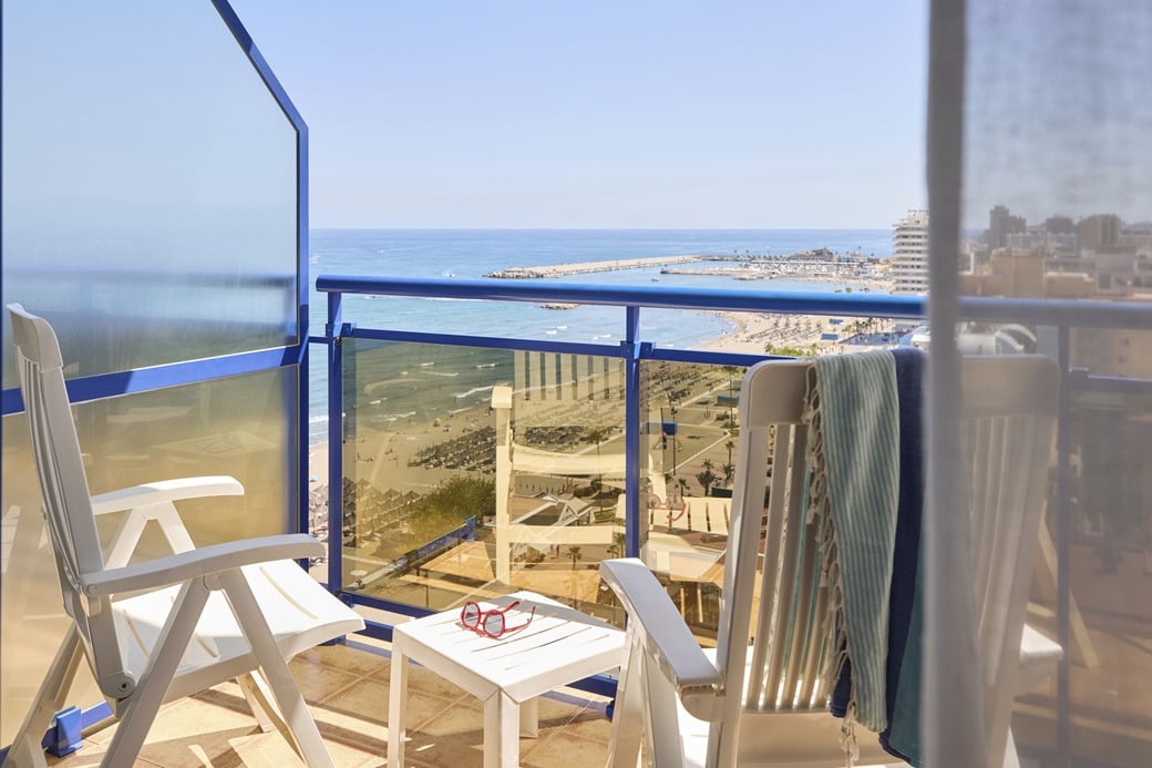 Hotel balcony with chairs and sea view Yaramar.