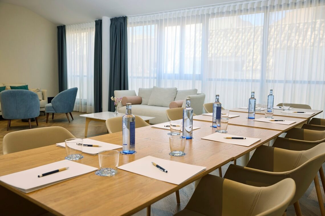 Nautical Room Meeting room with wooden table, chairs, water bottles and sofa. Yaramar