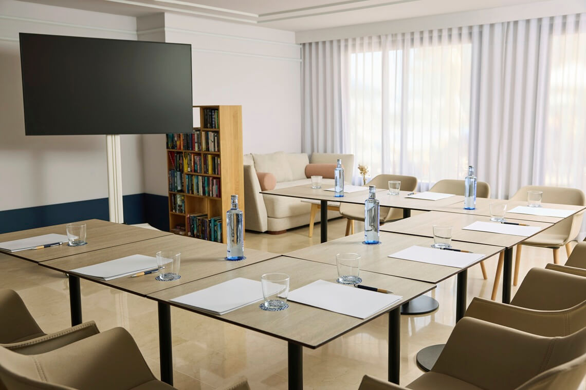 Litoral Room Modern meeting space with tables, chairs, Yaramar, and bookshelves.