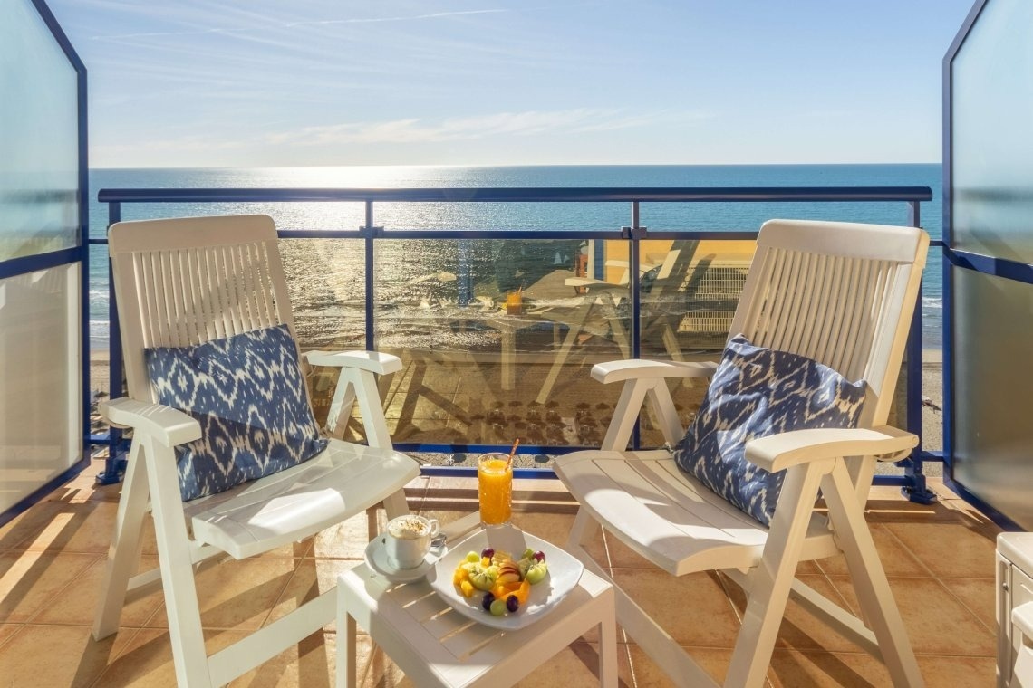 a hotel room with a sliding glass door leading to a balcony