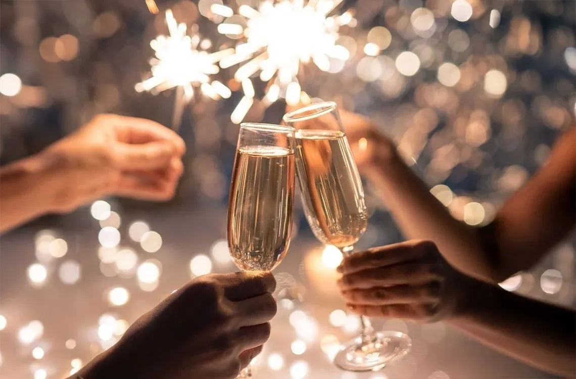 a group of people toasting with champagne and sparklers