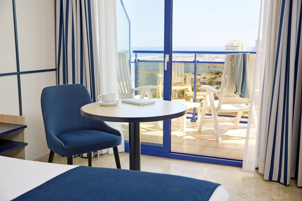 Blue chair and table with sea view balcony, ideal for your Yaramar.
