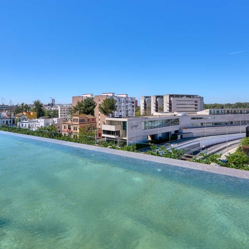 Rooftop infinity pool with city views, near Hotel Ybarra Sevilla.