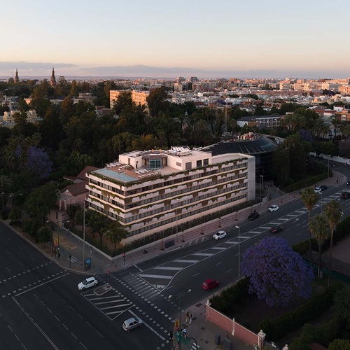 Modern hotel in Seville with lush greenery and city views.