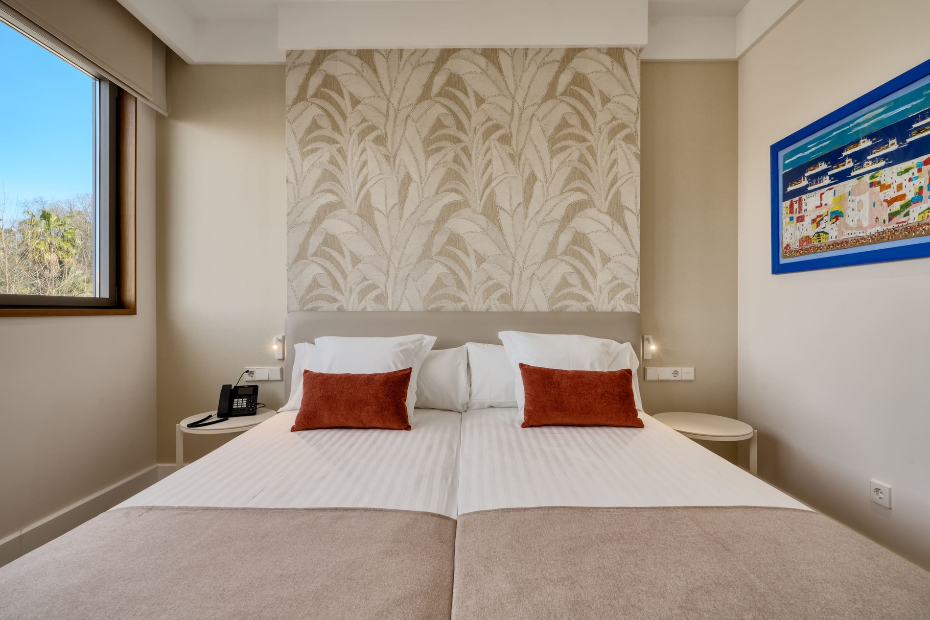 Comfortable beds with decorative pillows at Ybarra Sevilla hotel.