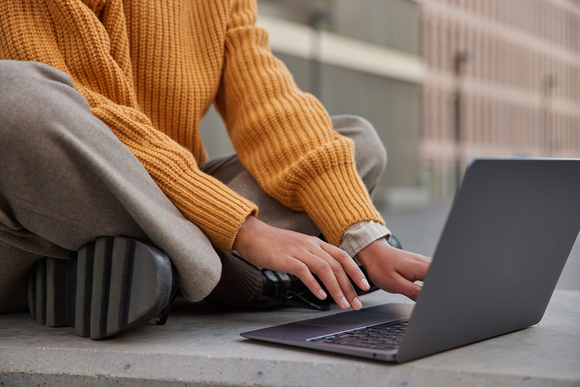 Person using laptop at Ybarra Sevilla, a modern co-working space.
