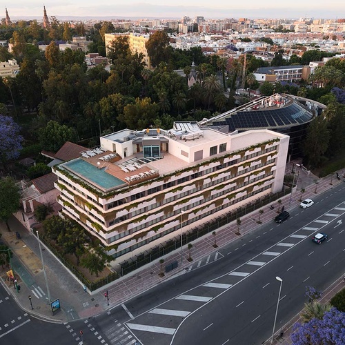 Luxury hotel Ybarra Sevilla with rooftop pool and city views.
