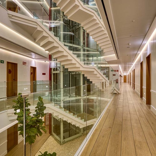 Modern hotel interior with central staircase, Ybarra Sevilla.