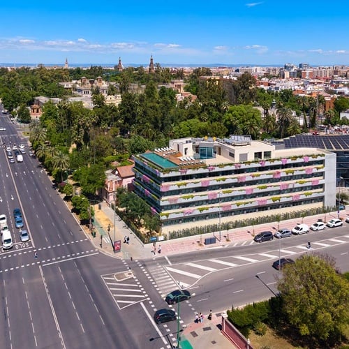 Ybarra Hotel Sevilla: modern facade with rooftop pool and city views.