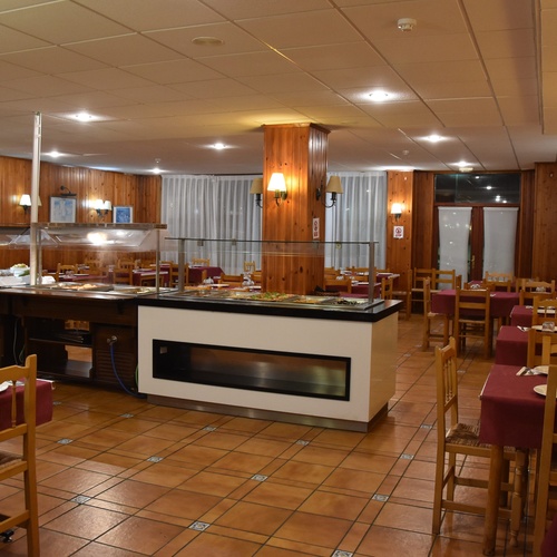 a restaurant with tables and chairs and a buffet