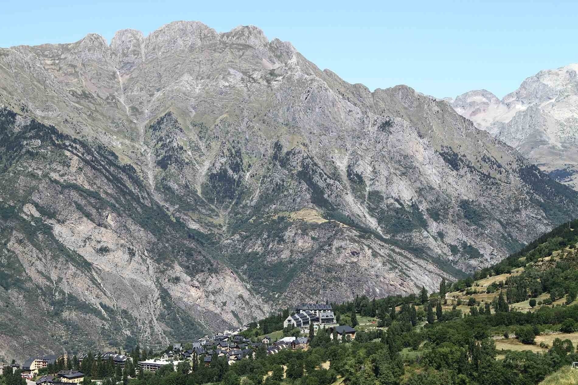 a mountain range with a small town in the foreground