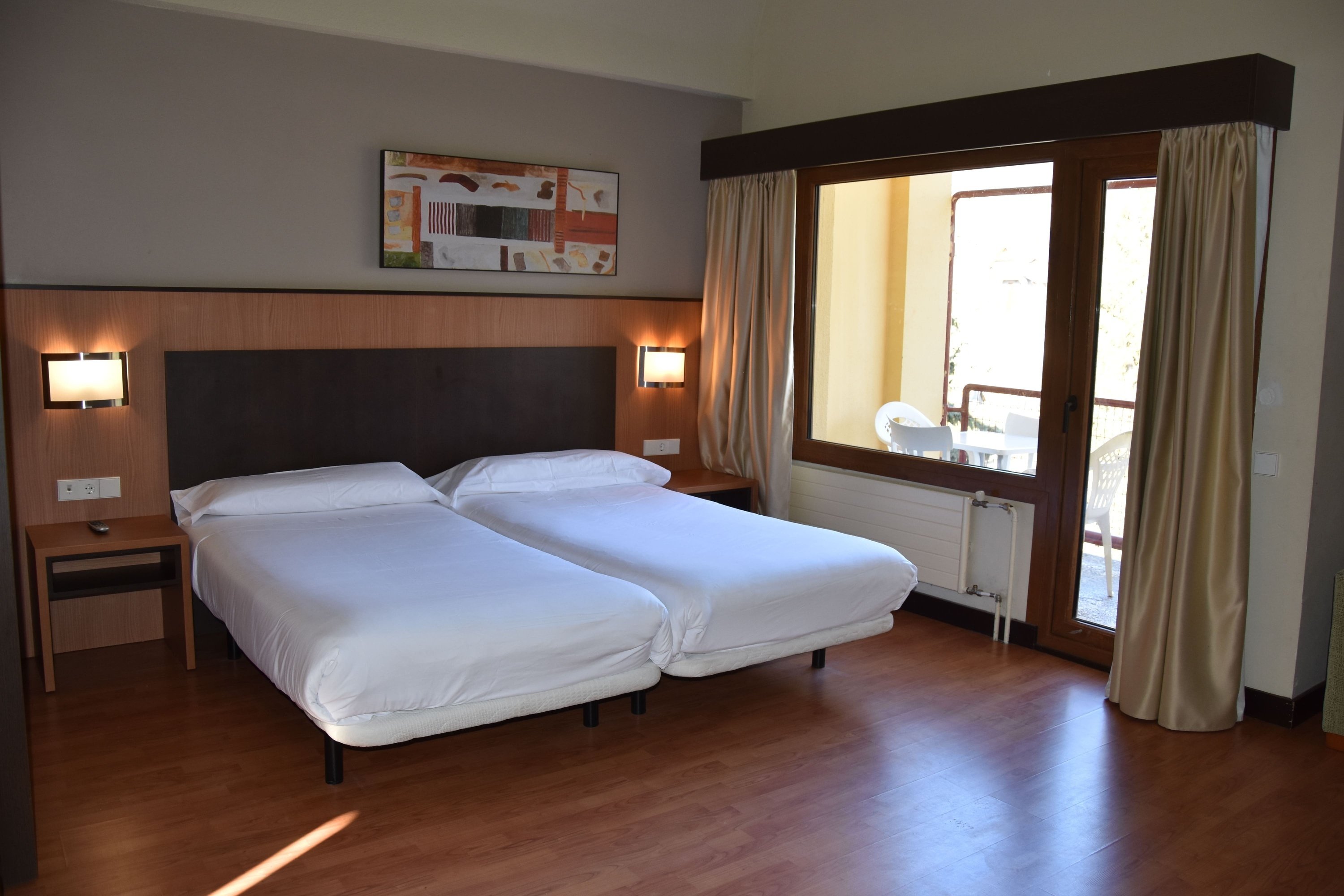 a hotel room with two beds and a large window